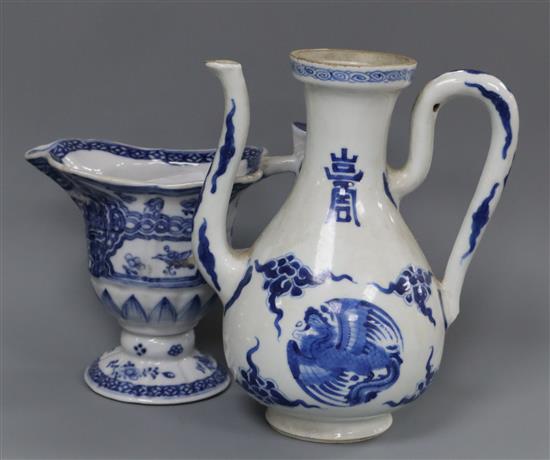 A Chinese Kangxi period blue and white wine pot and a Qianlong period helmet shaped milk jug Height of pot 16cm